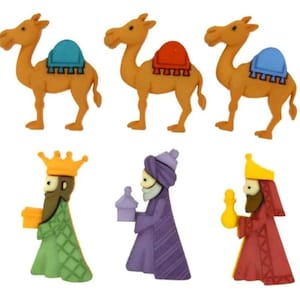 May include: Set of six felt Christmas ornaments featuring three camels with colorful saddles and three wise men holding gifts. The camels are brown and the wise men are wearing colorful robes and crowns.