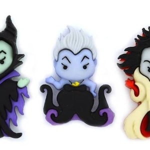 May include: Three cartoon character figurines: Maleficent in black and purple, Ursula in blue and black, and Cruella de Vil in black, white, and cream. Each figure has a unique design and facial expression, set against a white background.