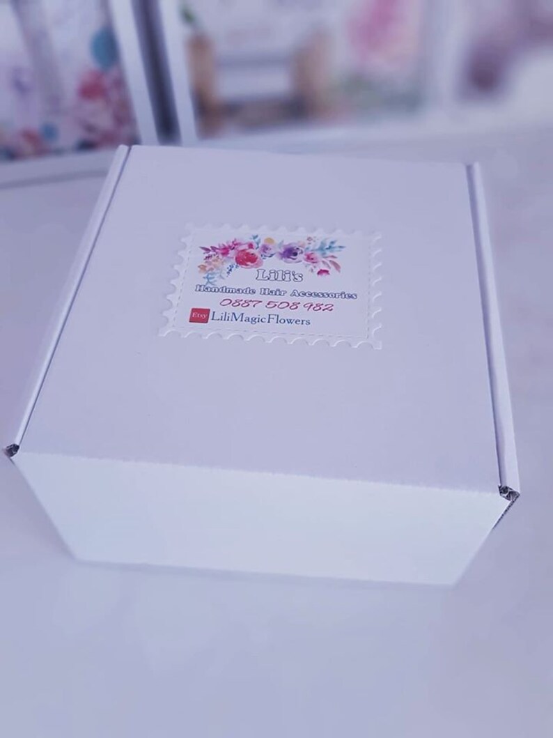 May include: White box with a sticker that says "Lili's Handmade Hair Accessories" with a floral design and the text "Etsy LiliMagicFlowers 0887 508 982".