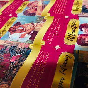 May include: A set of pink and gold tarot cards with romantic illustrations and text. The cards display images of couples and phrases such as "Soulmate," "Attraction," and "Magnetic Souls."