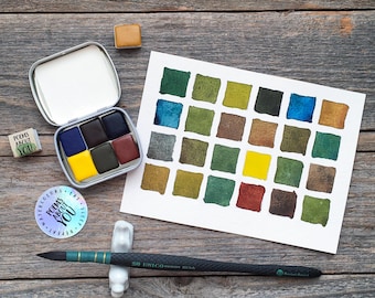 May include: A metal watercolor tin containing six paint pans, a white paper swatch card with twenty-eight painted color squares, a black paintbrush, a small stamp reading POEMS ABOUT YOU, and a circular sticker with the text POEMS ABOUT YOU.
