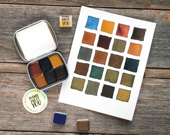 May include: A metal watercolor tin containing six paint pans, a white paper swatch card with twenty-four painted squares in various earth tones, a small square stamp reading POEMS ABOUT YOU, and a round sticker with the same text.