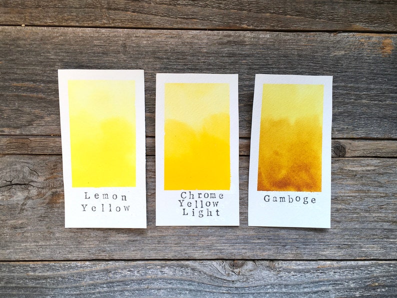 May include: Three watercolor paint swatches on white paper, labeled "Lemon Yellow", "Chrome Yellow Light", and "Gamboge".