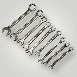 May include: A set of eight silver Craftsman wrenches of varying sizes, arranged diagonally. Each wrench has a different size marking, such as 7/16, 3/8, and 5/32, along with the Craftsman brand name and model number 42326.