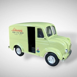 May include: A light green toy delivery truck with black tires and silver rims. The truck has the text "Schwan's Dairy & Ice Cream" on the side. A small ice cream cone graphic is on the door.