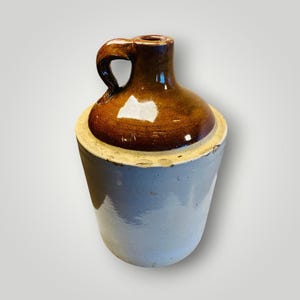 May include: A set of three ceramic mugs with a speckled, matte finish. The mugs are in shades of cream, light gray, and dark gray. Each mug has a simple, minimalist design, perfect for coffee or tea.