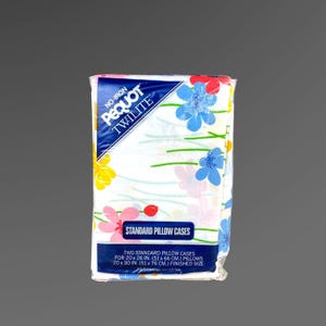 May include: A package of two standard pillow cases. The pillowcases are white with a floral pattern in pink, yellow, and blue. The package reads "Pequot Twilite" and includes the dimensions for 20 x 26 inch and 20 x 30 inch pillows.