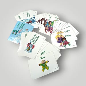 May include: A collection of vintage Cabbage Patch Kids playing cards. The cards feature illustrations of the dolls and other characters, with text such as "1'Kid", "2'Kids", and character names like "Colonel Casey" and "Stumble BunnyBee".