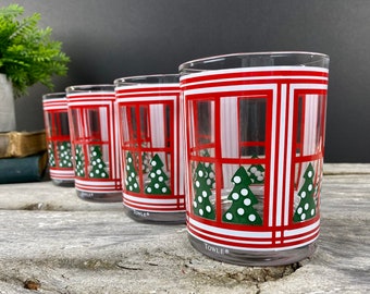 May include: Set of four clear glass tumblers with a red and white striped design and a green Christmas tree window scene. The glasses are marked "Towle".