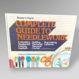 May include: A Reader's Digest book titled "Complete Guide to Needlework" with orange text on a blue background. The book cover features a variety of needlework techniques, including embroidery, knitting, and crochet. Colorful spools of thread, scissors, and an embroidery hoop are also visible.