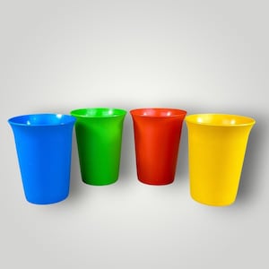 May include: Four colorful plastic cups in blue, green, red, and yellow. The cups are cylindrical with a slightly flared rim. These reusable cups are suitable for everyday use and are a vibrant addition to any kitchen or picnic.