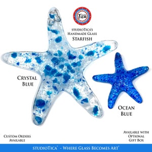 May include: Two handmade glass starfish, one in crystal blue with blue flecks and one in ocean blue. The text "STUDIOTICA'S HANDMADE GLASS STARFISH" is above the starfish. The text "CRYSTAL BLUE" is below the larger starfish and the text "OCEAN BLUE" is below the smaller starfish. The text "STUDIOTICA - WHERE GLASS BECOMES ART" is below the starfish.
