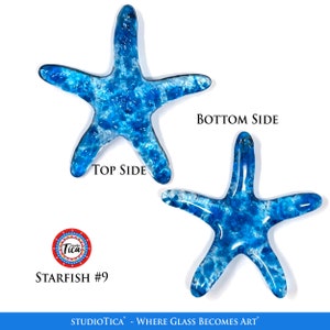 May include: Two blue glass starfish with a white marbled effect. The starfish are shown from the top and bottom sides. The image includes the text "Studiotica - Where Glass Becomes Art" and "Starfish #9".