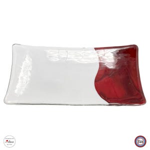 A rectangular glass tray is shown flat against a white background, with a solid white left side and a dark red marbled right side.