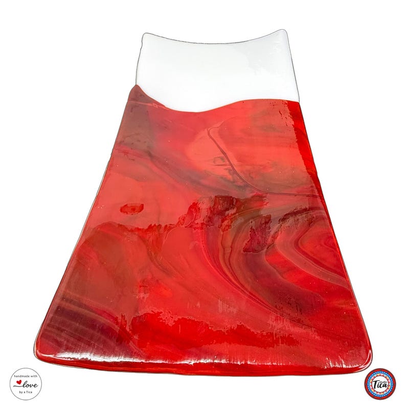 A curved rectangular glass tray stands upright against a white background, featuring a small white top section and a large red marbled body.