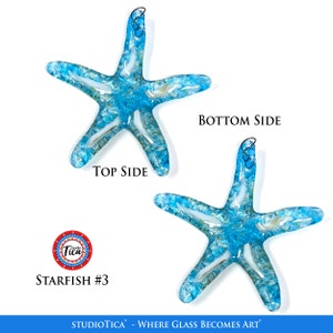 May include: Two blue glass starfish ornaments with a white and gold swirl design. The starfish are hanging from a wire loop. The text "Studio Tica - Where Glass Becomes Art" is at the bottom of the image. The text "Starfish #3" is in the lower left corner of the image.