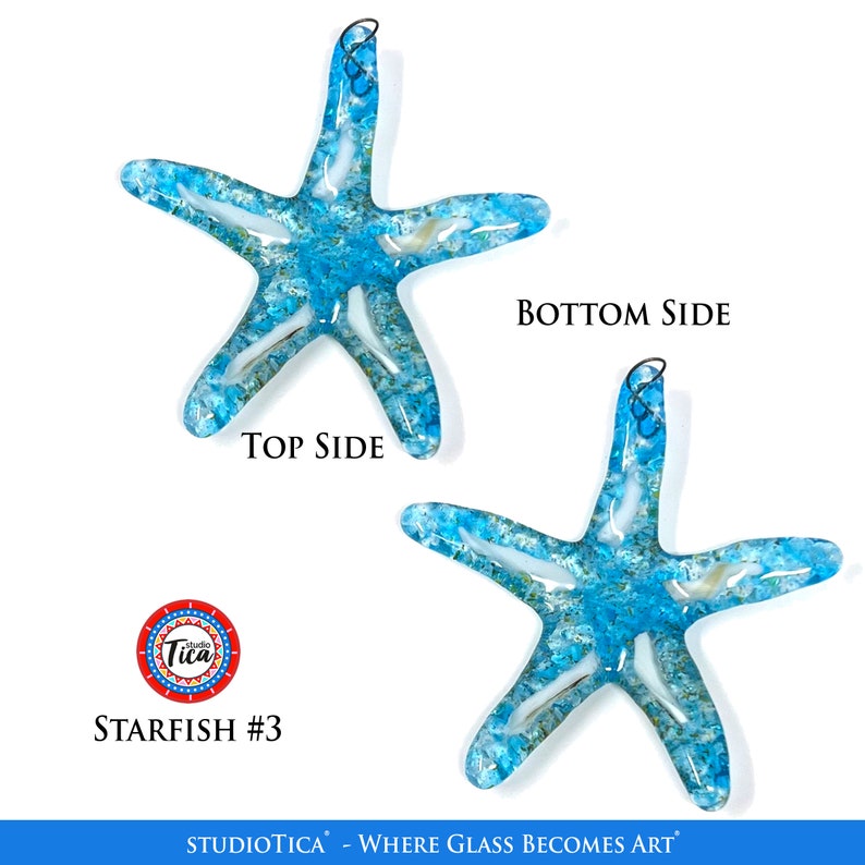 May include: Two blue glass starfish ornaments with a white and gold swirl design. The starfish are hanging from a wire loop. The text "Studio Tica - Where Glass Becomes Art" is at the bottom of the image. The text "Starfish #3" is in the lower left corner of the image.
