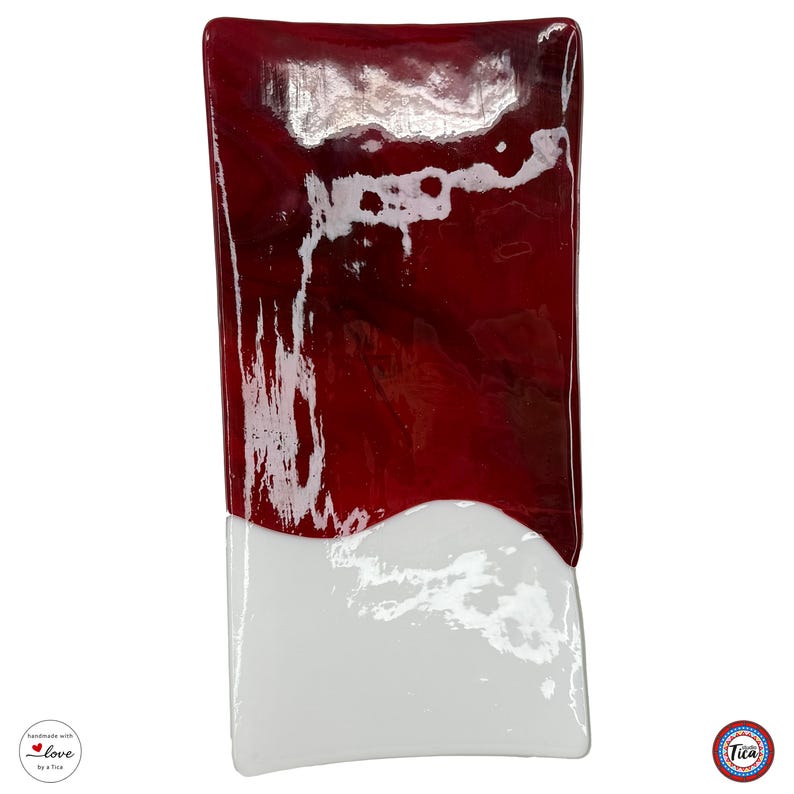 A rectangular glass tray is positioned vertically on a white background, displaying a deep red marbled pattern taking up most of the tray and a white section at the bottom.