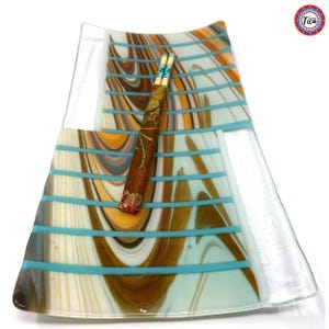A top-down view of the rectangular glass tray displaying brown, white, and copper swirled stripes with turquoise horizontal bars and chopsticks.