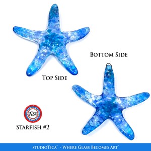 May include: A blue glass starfish ornament with a white swirl design. The ornament has a metal hanger on the back. The ornament is labelled "Studio Tica - Where Glass Becomes Art" and "Starfish #2".