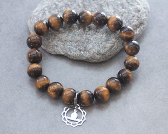 Pulsera elaborada con piedras naturales, cuentas de ojo de tigre y charm de Buda de acero inoxidable.