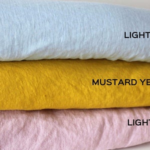 May include: Three fabric swatches stacked on top of each other. The top swatch is light blue, the middle swatch is mustard yellow, and the bottom swatch is light pink. The swatches are labeled "LIGHT BLUE", "MUSTARD YELLOW", and "LIGHT PINK".