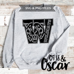 May include: A gray sweatshirt with a black and white graphic of a 'W' with a wildcat face inside and the word 'WILDCATS' written vertically next to it. The words 'OTIS & Oscar' are written in black cursive at the bottom of the sweatshirt.