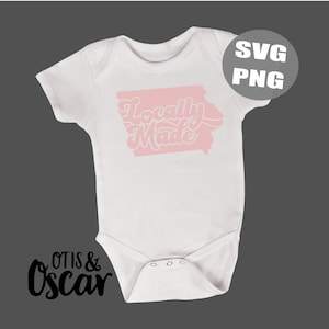 May include: White baby bodysuit with a pink Iowa state outline and the words "Locally Made" in a retro font. The design includes the text "SVG PNG" in a circle. The Otis & Oscar logo is in the bottom left corner.