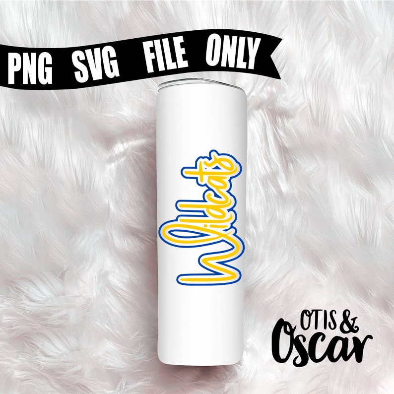 May include: White tumbler with a yellow and blue Wildcats design. The tumbler is on a white fluffy surface. The text Otis & Oscar is in black below the tumbler.