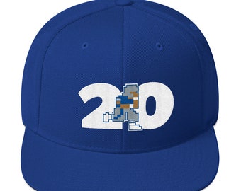 May include: A royal blue baseball cap with a white embroidered number "20" and a pixelated football player in the center.