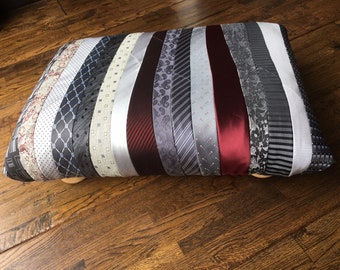Handmade foot stool upholstered with recycled neck ties. Grey, silver and burgundy stripes.