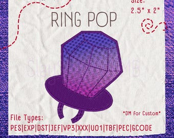 May include: An embroidery design of a Ring Pop candy featuring a purple and pink gradient faceted gem on a purple band. The text reads RING POP, Size: 2.5" x 2", and File Types: PES|EXP|DST|JEF|VP3|XXX|U01|TBF|PEC|GCODE. The design is on white fabric.