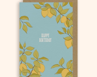 May include: A greeting card with a light blue background and a brown border. The card features a botanical illustration of lemons and leaves. The words "HAPPY BIRTHDAY" are printed in white. The card is a standard size.