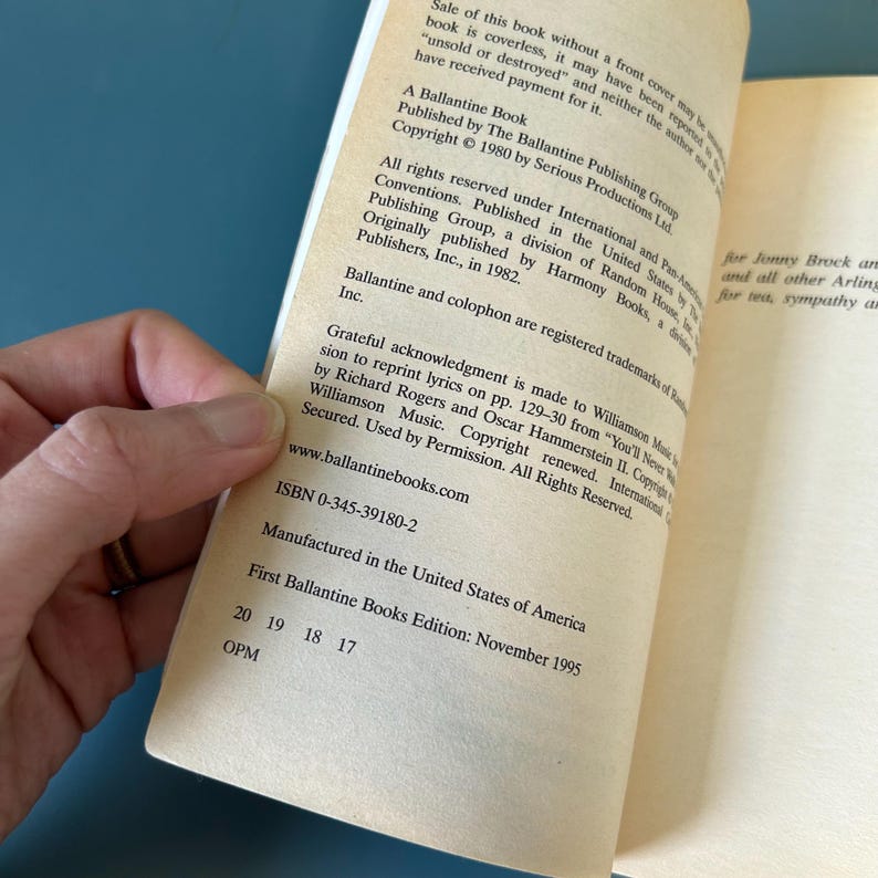 May include: An open book showing text from a Ballantine Book. The text includes copyright details, ISBN, and the edition date of November 1995. The book is open, revealing the inside pages.