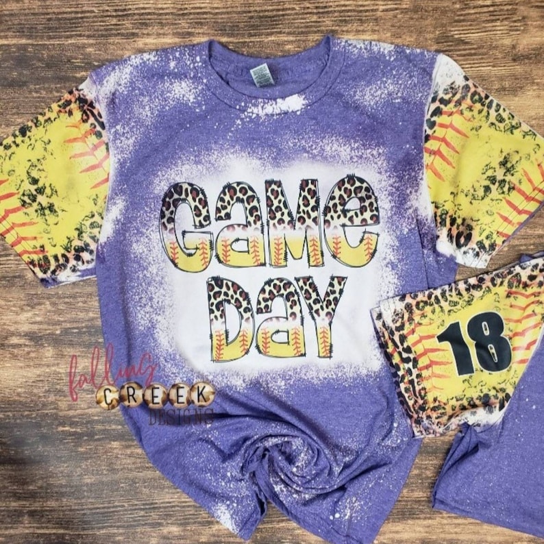 Game Day,  softball and leopard distressed letters. Softball and leopard distressed sleeves, front and back bleached tshirt.