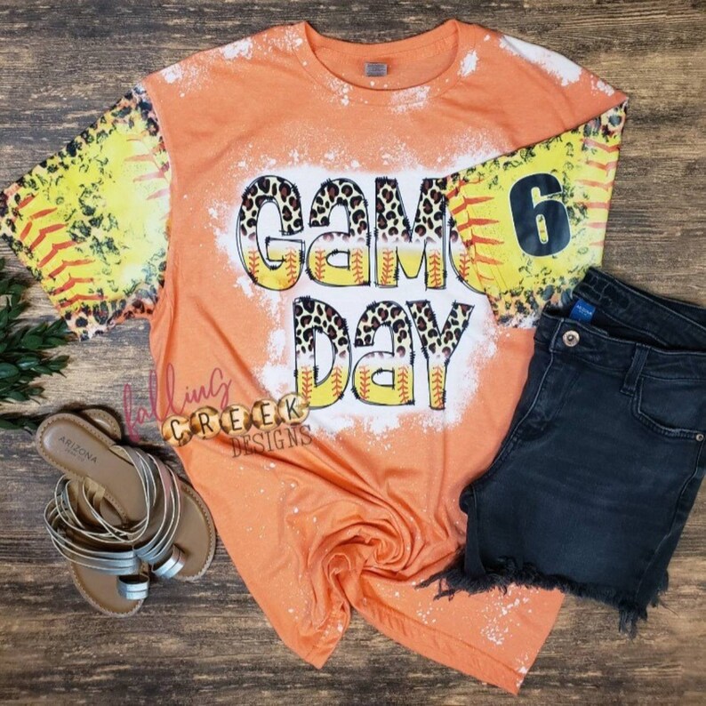 Game Day,  softball and leopard distressed letters. Softball and leopard distressed sleeves, front and back bleached tshirt.