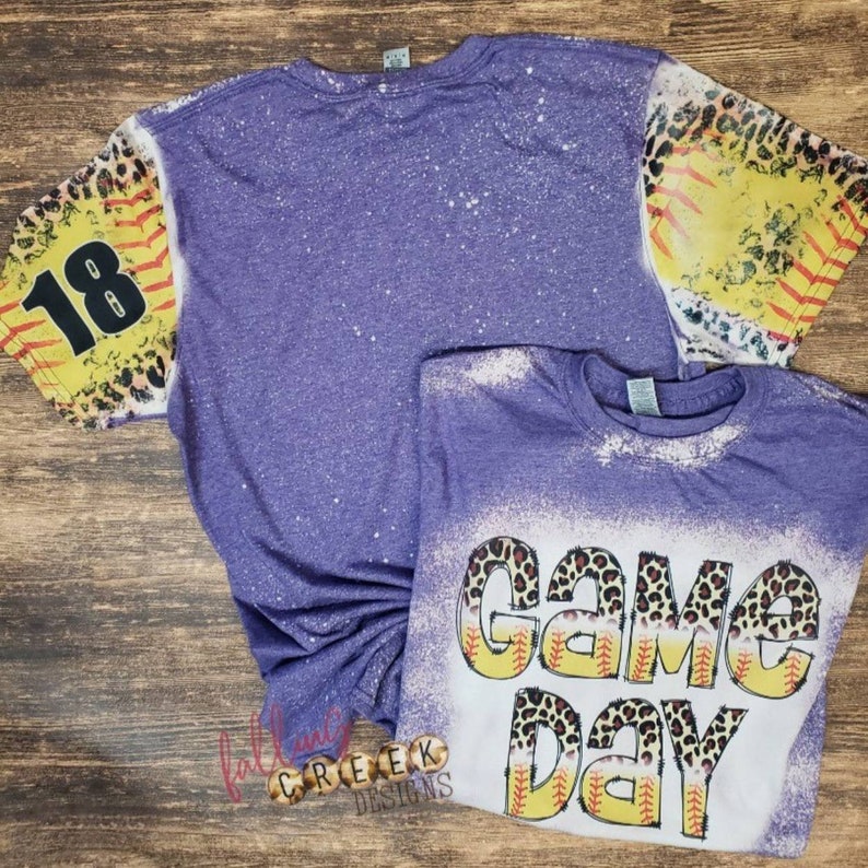 Game Day,  softball and leopard distressed letters. Softball and leopard distressed sleeves, front and back bleached tshirt.