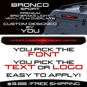 May include: Customisable third brake light vinyl overlay for a Ford Bronco Sport. The overlay is black with a red, illuminated text area that says "YOUR CUSTOM TEXT HERE". The image shows the overlay installed on the vehicle. You can choose the font and text or logo for your overlay.