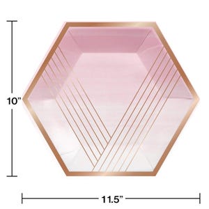 May include: Pink and white ombre hexagonal paper plates with a rose gold geometric design. The plates measure 10 inches in diameter and 11.5 inches across.