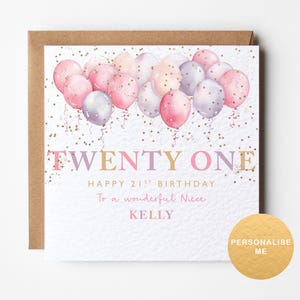 May include: A birthday card with a watercolour design. The card features pink, purple, and white balloons, with the words "TWENTY ONE" and "HAPPY 21ST BIRTHDAY" in a decorative font. The card is personalised with a name.