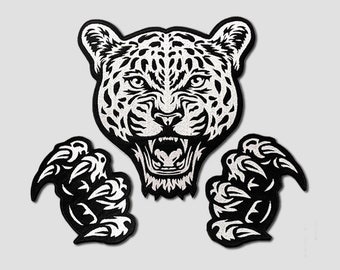 May include: Black and white embroidered patch of a snarling leopard with sharp claws. The leopard's face is detailed with a white outline and black spots. The claws are also outlined in white.