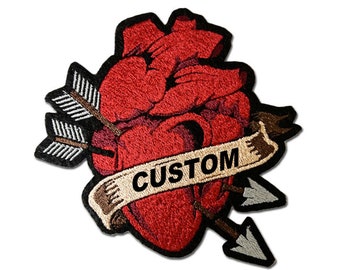 May include: Embroidered patch depicting a red heart pierced by an arrow. A banner across the heart reads "CUSTOM" in black letters. The patch has a black border and is set against a white background.