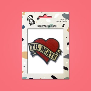 May include: Iron-on velcro patch with a red heart and the text "Til Death" in a gold banner.