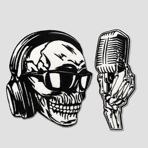May include: Black and white illustration of a skull wearing headphones and sunglasses, holding a microphone. The skull is smiling and has a retro style.