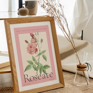 floral rose painting sits in wooden frame next to a coffee table