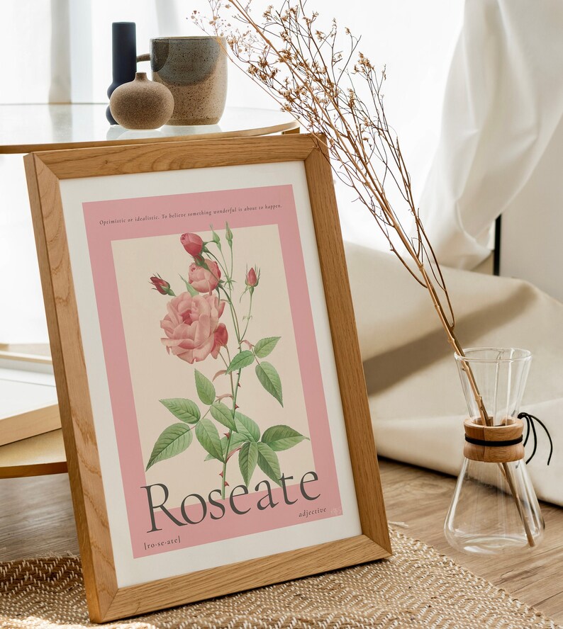 floral rose painting sits in wooden frame next to a coffee table