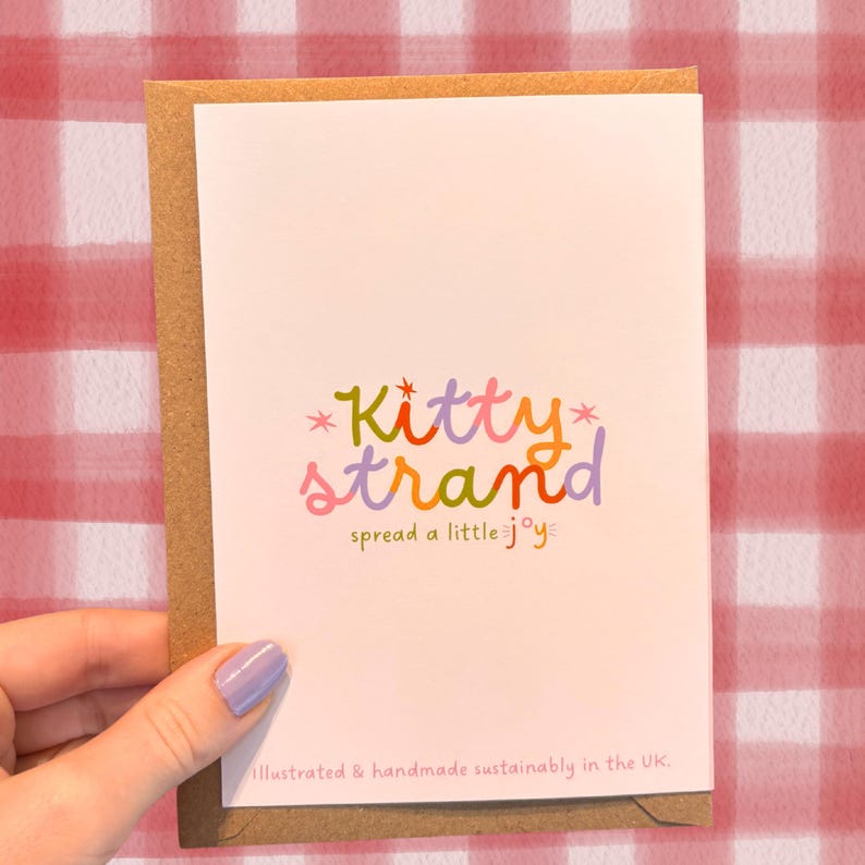 worm Valentine's Day card. pink Valentine's day card with an illustration of two worms surrounded by love hearts and text reading Would I still be your valentine if I were a worm? in red typography. Valentine's Day card for boyfriend, husband or partner held by a woman in front of a cosy background