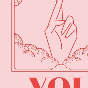 Close up of Lucky art is pink and red and inspired by retro tarot art. At the bottom of the art, retro red typography reads LUCKY YOU