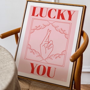 Mid-Century wooden arm chair with pink and red fingers crossed lucky you poster