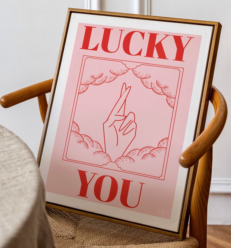 Mid-Century wooden arm chair with pink and red fingers crossed lucky you poster